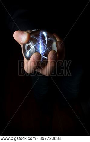 Holding Atom In Fortune Teller Magic Crystal Ball