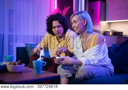 Handsome Young Man Teaching How To Play The Video Games To His Girlfriend, On The Couch, Concept Abo