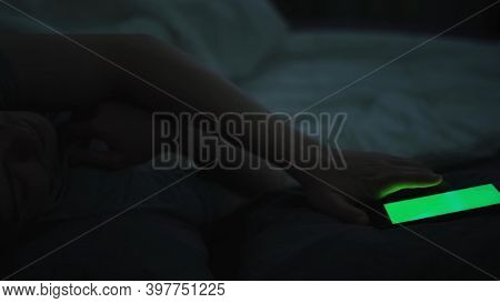 Young Man Waking Up With Mobile Alarm Clock With Green Screen Early In The Morning. Concept. Sleepy 