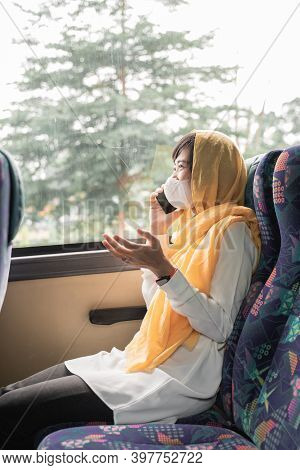 Muslim Woman With Face Mask Using Her Mobile Phone