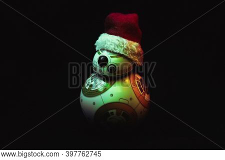 Caba, Argentina, November 28, 2020: Lovely Droid Bb-8 From Star Wars, Wearing A Christmas Hat In Dar