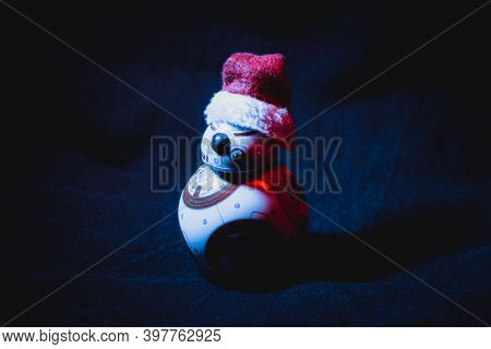 Caba, Argentina, November 28, 2020: Lovely Droid Bb-8 From Star Wars, Wearing A Christmas Hat In Dar