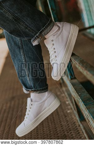 White canvas sneakers on jeans model