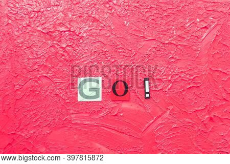 Cut Out Letters And Composed Word Go! On Blurred Pink Background