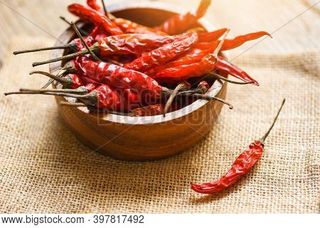 Dried Chili On Bowl / Red Dried Chilli Pepper Cayenne On Sack Background