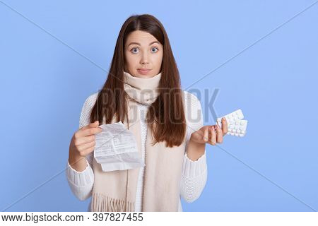 Astonished Woman Holding Pills With Instruction And Looking At Camera With Puzzled Facial Expression