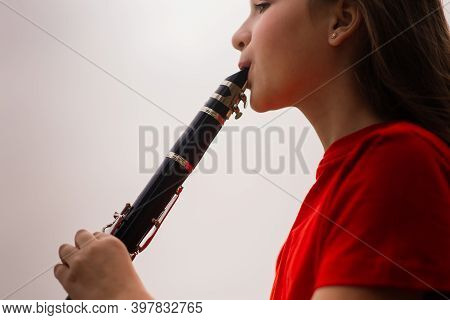 Young Attractive Girl Playing Clarinet, Ebony In Fall Park