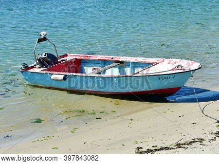 Portosin, Spain. July 3, 2020. Galician Old Wooden Motor Boat Moored On A Beach. Rias Baixas, Coruña