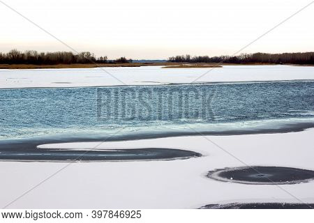 Ice-hole On The River Wormwood On The River Thin Ice Washes Away With Water And Holes Form In The Ic