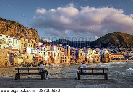Cefalu, The Medieval Village Of Sicily Island, Province Of Palermo, Italy. Europe, A Couple On Vacat
