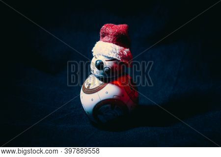 Caba, Argentina, November 28, 2020: Lovely Droid Bb-8 From Star Wars, Wearing A Christmas Hat In Dar