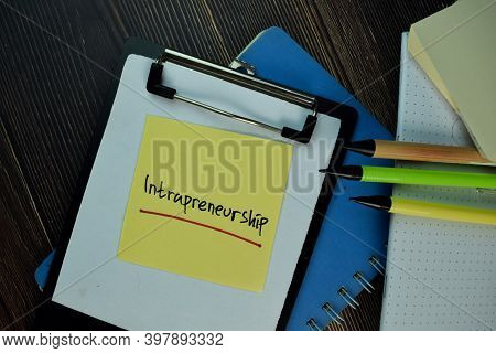 Intrapreneurship Write On Sticky Notes. Isolated On Wooden Table.