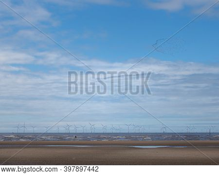 The Beach At Blundell Sands In Sefton Near Southport With Waves Braking On The Beach And The Wind Tu