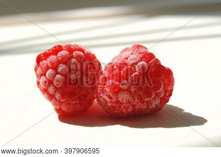 Two Berries Of Frozen Raspberries, Light Sun And Shadow
