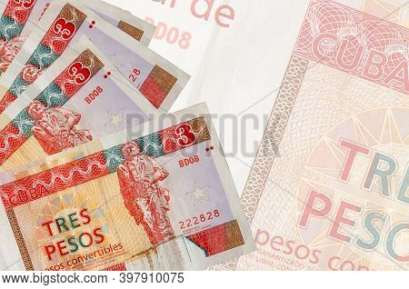 3 Cuban Pesos Convertibles Bills Lies In Stack On Background Of Big Semi-transparent Banknote. Abstr