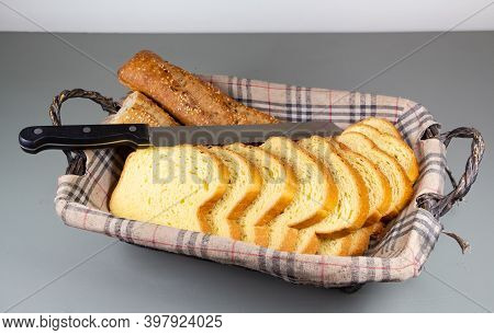 Baguette Bread, Brioche And Knife In A Breadbasket For Breakfast
