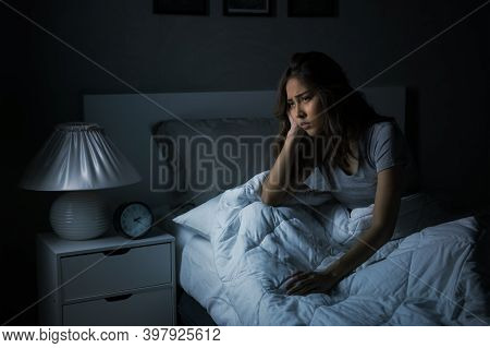Depressed Young Asian Woman Sitting In Bed Cannot Sleep From Insomnia