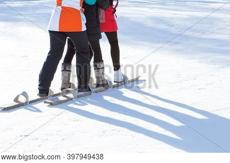 Irkutsk, Russia- 8 January 2019: Three Young Girls Skiing In Winter Park In Ethnographic Museum Talt