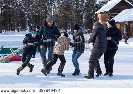 Irkutsk, Russia- 8 January 2019: Happy People Having Fun Playing Tug-of-war In Museum Taltci.