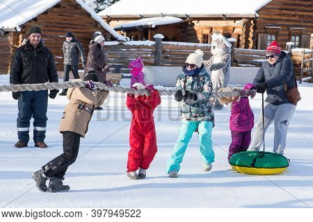 Irkutsk, Russia- 8 January 2019: Happy Families With Children Having Fun Playing Tug-of-war In Museu