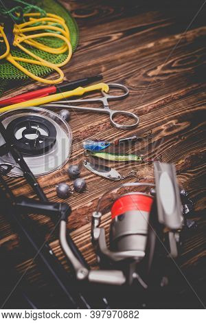 Fishing Tackle On A Wooden Background. Studio Photo With Vignetting.