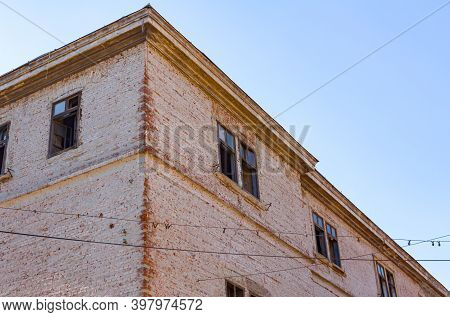 Bottom Side View On Damaged Facade Of Building With Bricks And Broken Windows, Exterior Of An Old Bu