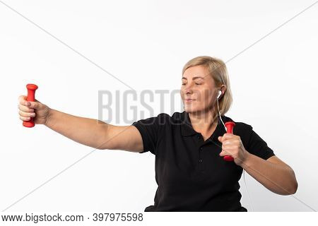 Fitness Woman At Home In Headphones With Dumbbells. Photo On A White Background.