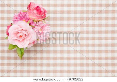 Artificial Rose On The Table Cloth
