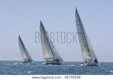 View of three yachts compete in team sailing event