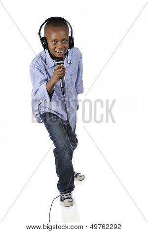 Full-length image of an elementary DJ happily singing into a mike.  On a white background.
