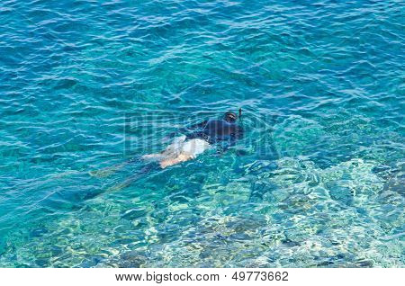 Diver or snorkler at Aegean sea near small greek island