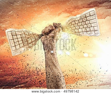 Human hand clenching keyboard