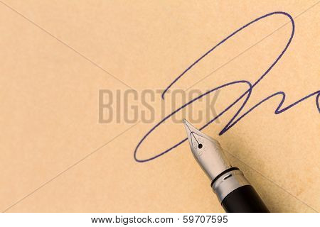 a signature and a fountain pen on yellow paper. symbolic photo for contract testament and graphology