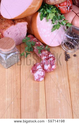 Lot of different sausages on wooden table close-up