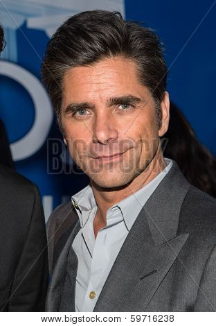 NEW YORK-JAN 29: Actor John Stamos (R) visits the Dannon Oikos Tent on Park Avenue on January 29, 2014 in New York City.