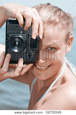 Woman laughing as she views a photo