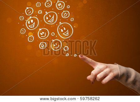 Group of happy hand drawed smiley faces coming out of gun shaped hands