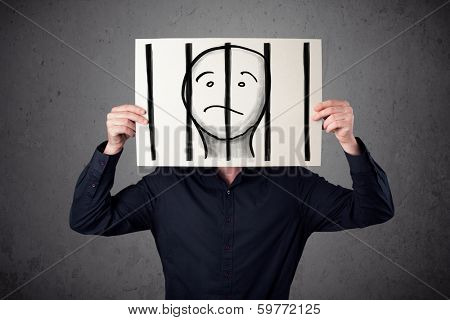 Businessman holding a paper with a prisoner in jail behind the bars on it in front of his head