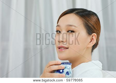 .a Young Woman With A Bathrobe Enjoying Tea.