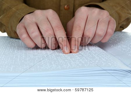Blind woman read book written in Braille
