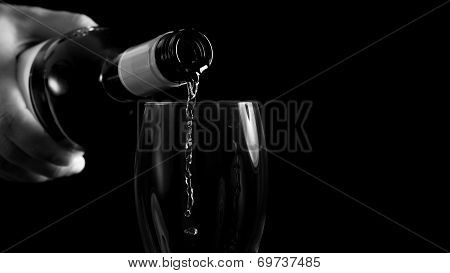 Man Pouring White Wine Into A Glass