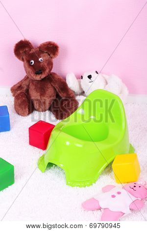 Green potty on home interior background