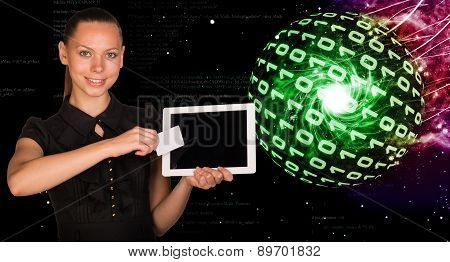 Smiling young woman holging tablet and card