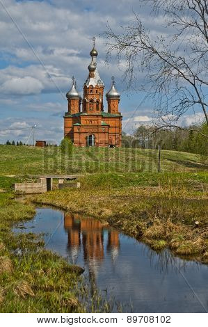 A Brick Church On The Water In Russia