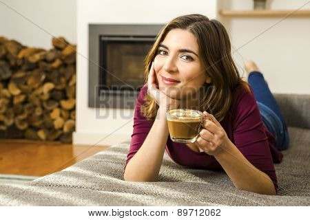 Beautiful woman at home drinking a capuchino