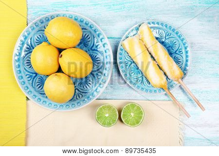 Lemons and ice cream on plates on table top view