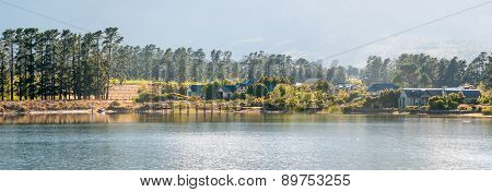 Early Morning Panorama Of Houses Next To A Dam
