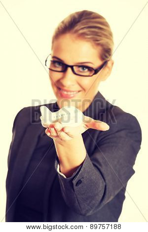Beautiful businesswoman with plane toy in hand