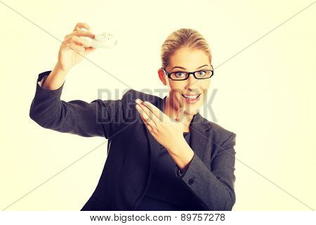 Beautiful businesswoman with plane toy in hand