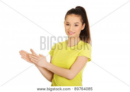 Happy teenager clapping her hands.